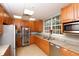 Kitchen with stainless steel appliances, granite countertops, ample cabinet space, and a large window view at 560 Misty Pine Dr, Venice, FL 34292