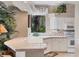 Well-lit kitchen featuring tile countertops, modern appliances, ample cabinetry, and a picturesque window view at 560 Misty Pine Dr, Venice, FL 34292