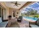Inviting screened lanai with a view of the pool, outdoor seating, and stylish decor at 560 Misty Pine Dr, Venice, FL 34292