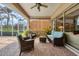 Relaxing screened lanai with comfortable seating and views of the surrounding landscape at 560 Misty Pine Dr, Venice, FL 34292