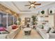 Bright and airy living room featuring neutral tones, tile flooring, and stylish furnishings at 560 Misty Pine Dr, Venice, FL 34292