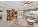Bright living room with patio access, comfortable seating, and built-in shelving at 560 Misty Pine Dr, Venice, FL 34292