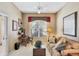 Comfortable living room with a classic desk, bright window, and cozy furnishings at 560 Misty Pine Dr, Venice, FL 34292