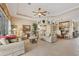 Bright living room with neutral walls, tile floors, tray ceilings, and an open layout to the dining area at 560 Misty Pine Dr, Venice, FL 34292