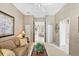 Cozy living room featuring neutral tones, a ceiling fan, and an open doorway to the home's interior at 560 Misty Pine Dr, Venice, FL 34292