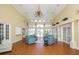 Bright lobby with high ceilings, chandelier, ample seating, and large windows offering beautiful views at 560 Misty Pine Dr, Venice, FL 34292
