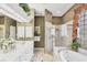 The bathroom boasts a double vanity, a luxurious soaking tub, and a glass-enclosed shower at 560 Misty Pine Dr, Venice, FL 34292