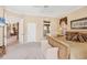 Carpeted main bedroom showcasing a decorative bed frame, adjoining bathroom and living spaces at 560 Misty Pine Dr, Venice, FL 34292