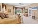 The main bedroom offers a serene view, enhanced by a flat screen TV and a private entrance at 560 Misty Pine Dr, Venice, FL 34292