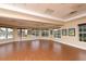Versatile meeting room with wood flooring, a wall of windows, and an American flag on display at 560 Misty Pine Dr, Venice, FL 34292