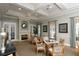 Inviting meeting room with a fireplace, elegant seating, and ample natural light from surrounding windows at 560 Misty Pine Dr, Venice, FL 34292