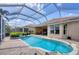 Inviting screened-in pool area featuring brick pavers and well-maintained landscaping at 560 Misty Pine Dr, Venice, FL 34292
