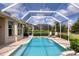 Private screened pool area surrounded by lush landscaping, providing a perfect oasis at 560 Misty Pine Dr, Venice, FL 34292