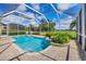 Enclosed pool with a spa, poolside seating, and views of the landscaped yard at 560 Misty Pine Dr, Venice, FL 34292