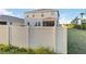 A fenced backyard with a view of the back of the house, including a screened-in porch at 5767 Woodland Sage Dr, Sarasota, FL 34238