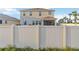 Fenced backyard with a view of the two-story home featuring a screened-in porch area at 5767 Woodland Sage Dr, Sarasota, FL 34238