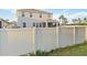 Backyard view of home with a screened-in porch and privacy fence, offering a serene outdoor space at 5767 Woodland Sage Dr, Sarasota, FL 34238