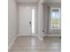 Bright foyer with tile flooring, white door, and adjacent window at 5767 Woodland Sage Dr, Sarasota, FL 34238