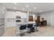 Open-concept kitchen featuring an island with seating, white cabinets, and modern appliances at 5767 Woodland Sage Dr, Sarasota, FL 34238
