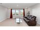 Bright living room featuring carpet, a leather sofa, large windows, and neutral paint at 5767 Woodland Sage Dr, Sarasota, FL 34238