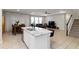 Inviting living room boasts an open floor plan, tile flooring, and a modern island with countertop at 5767 Woodland Sage Dr, Sarasota, FL 34238