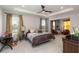 Spacious main bedroom featuring a tray ceiling, multiple windows, and neutral decor at 5767 Woodland Sage Dr, Sarasota, FL 34238