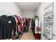 Functional walk-in closet featuring ample storage, hanging racks, and a convenient shoe organizer at 5767 Woodland Sage Dr, Sarasota, FL 34238