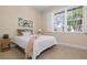 Bedroom featuring plantation shutters, natural light, and floral art at 612 Poinsettia Dr, Venice, FL 34285