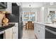 Modern kitchen with stainless steel appliances, white cabinets, and eat-in dining area with natural light at 612 Poinsettia Dr, Venice, FL 34285