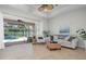 Bright living room featuring neutral decor and seamless access to the screened-in pool area at 612 Poinsettia Dr, Venice, FL 34285