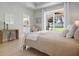 Bright primary bedroom with a sliding glass door to the patio, neutral walls, and tile flooring at 612 Poinsettia Dr, Venice, FL 34285