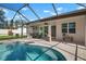 A screened pool area with brick pavers, a seating area, and access to the home through sliding glass doors at 612 Poinsettia Dr, Venice, FL 34285