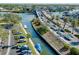 Aerial view of a bridge, water canal, and parking for boats at 6415 Midnight Pass Rd # 909, Sarasota, FL 34242