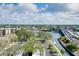 Aerial view of a waterway neighborhood highlighting the bridge, water and local businesses at 6415 Midnight Pass Rd # 909, Sarasota, FL 34242