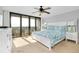 Spacious bedroom with ceiling fan, balcony access, and calming decor at 6415 Midnight Pass Rd # 909, Sarasota, FL 34242