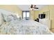 Bedroom featuring twin beds, TV, ceiling fan, and sliding glass doors to balcony at 6415 Midnight Pass Rd # 909, Sarasota, FL 34242