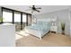 Bright bedroom features a ceiling fan, balcony, and nightstands at 6415 Midnight Pass Rd # 909, Sarasota, FL 34242