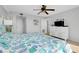 Bright bedroom with a dresser, ceiling fan, and colorful bedding at 6415 Midnight Pass Rd # 909, Sarasota, FL 34242