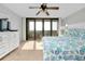 Well-lit bedroom featuring balcony access, dresser and television at 6415 Midnight Pass Rd # 909, Sarasota, FL 34242