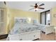 Bright bedroom featuring twin beds, ceiling fan, and sliding glass doors to balcony at 6415 Midnight Pass Rd # 909, Sarasota, FL 34242