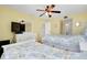 Bedroom featuring twin beds, TV, ceiling fan, and ensuite bathroom at 6415 Midnight Pass Rd # 909, Sarasota, FL 34242