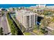 Aerial shot of the condo building on a bright, sunny day near the beach, and waterway at 6415 Midnight Pass Rd # 909, Sarasota, FL 34242