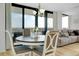 Elegant dining area with modern furnishings, pendant lighting, and sliding glass doors to the balcony at 6415 Midnight Pass Rd # 909, Sarasota, FL 34242