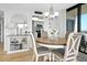 Bright dining area with a round table, stylish décor, and an adjacent living space at 6415 Midnight Pass Rd # 909, Sarasota, FL 34242