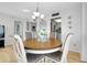 Cozy dining area features a round wood table, upholstered chairs, and decorative chandelier at 6415 Midnight Pass Rd # 909, Sarasota, FL 34242
