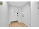 Clean condo entrance with light hardwood floors, featuring white doors at 6415 Midnight Pass Rd # 909, Sarasota, FL 34242