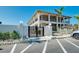 Exterior of condo building featuring private balconies, security gate, and allocated parking at 6415 Midnight Pass Rd # 909, Sarasota, FL 34242