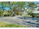 Well-maintained grounds with mature trees and shrubs at 6415 Midnight Pass Rd # 909, Sarasota, FL 34242