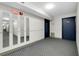 Hallway with mirrors accentuating the space, leading to apartments, well-maintained with tiled flooring at 6415 Midnight Pass Rd # 909, Sarasota, FL 34242