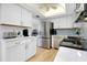 Bright kitchen with stainless steel appliances, white cabinets and countertops at 6415 Midnight Pass Rd # 909, Sarasota, FL 34242